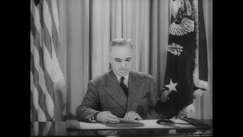 WASHINGTON DC - 1945: Suited Speaker Addresses Camera Between Flags Stock Footage 342856426