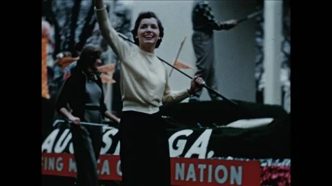 WASHINGTON DC - 1953 - Golfers wave to the crowd as they flanks a float at Stock Footage 327747210