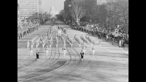 WASHINGTON DC - 1961 - A large drum is being wheeled by a high school marching Stock Footage 341991971
