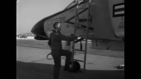 WASHINGTON DC - 1961 - A pilot climbs into the cockpit of an F4 Phantom, it 스톡 동영상 312793811