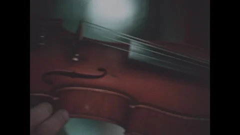 Washington DC 1970s: A man in a hat and bow tie plays the violin. A small object Stock Footage 340658401