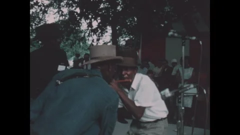 Washington DC 1970s: A man in a hat and white shirt plays large drums during an Stock Footage 340658849