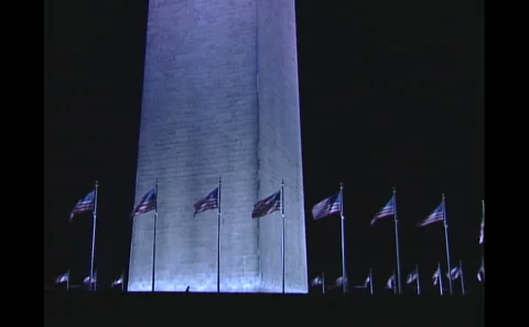 Washington Memorial surrounded by waving flags Video stock 242497017