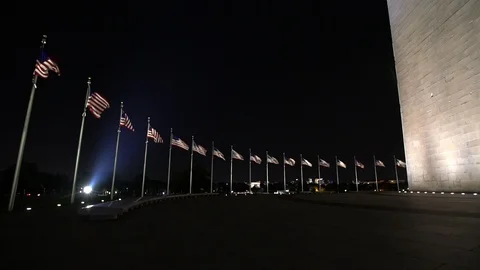 Washington Monument, many US flags at night Stock Footage 125251953