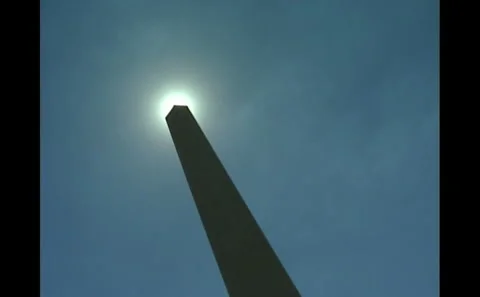 Washington Monument seen backlit by sun Stock Footage 242498300