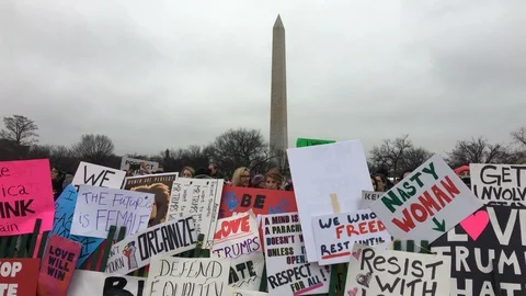 The Washington Monument is seen behind a wall of signs during the Women's Mar Video stock 125867945