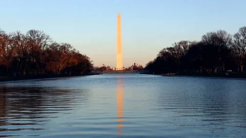 Washington  Monument at sunset with reflecting pool Stock Footage 132332745