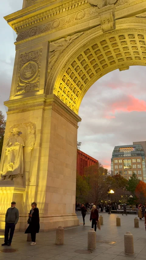 Washington Square Arch is lit up against the sunset at dusk in Greenwich Village Vídeo Stock 342085565