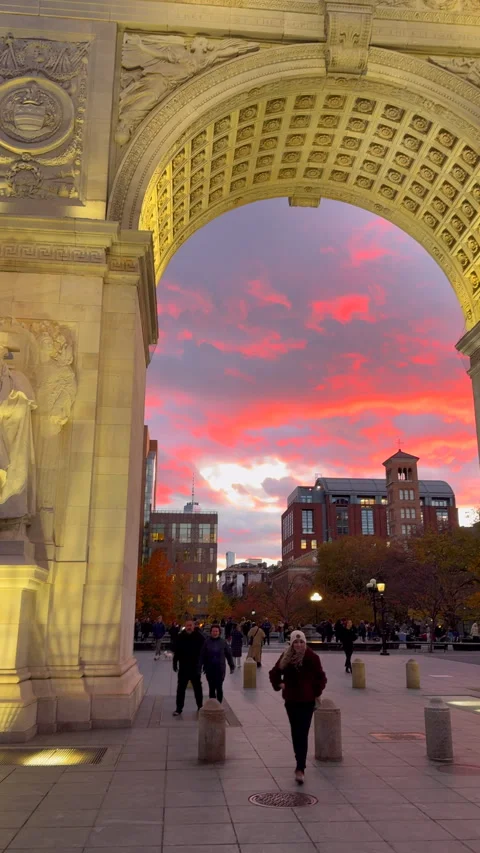 Washington Square Arch is lit up against the sunset at dusk in Greenwich Village 库存影片 342086217