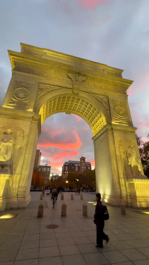 Washington Square Arch is lit up against the sunset at dusk in Greenwich Village 库存影片 342087126