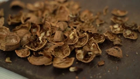 Waste after peeling a walnut, close-up. Smooth camera glide Stock Footage 239401683
