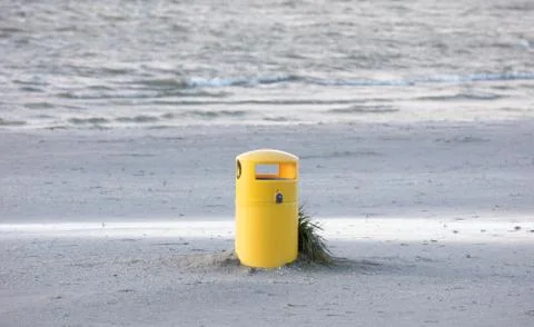 Waste bin on a sandy beach Stock Photos
