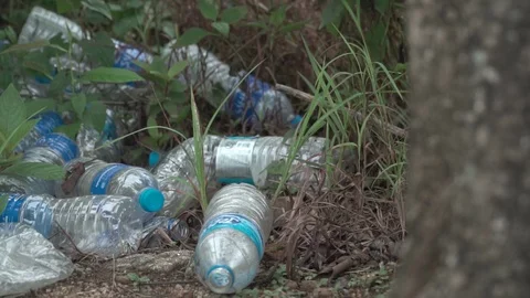 Waste bottle flowing through water reflection 60fps plastic pollution water Video stock 110776629