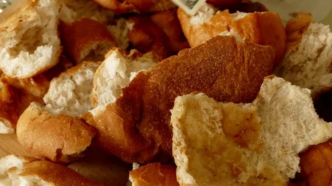 Waste of bread and 100 usa banknotes, stale bread and material damage 動画素材 106688945