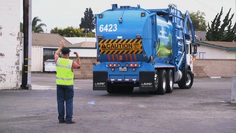 Waste Collections Truck Backing Up With Assistance Stock Footage