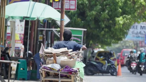 Waste Collector Pulling a Cart While Collecting Recyclable Materials Stock Footage 345618839