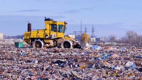 Waste, garbage, dump, rubbish 4K. A landfill compactor working at a lanfill site Stock Footage
