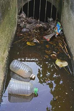 Waste from the garbage in the storm drain Stock Photos