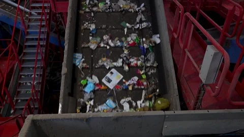 Waste load moving along elevated conveyor route in recycling plant Stock Footage 333345294
