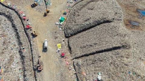 Waste Loaded Trucks Approaching An Open Dump Yard To Unload Stockbeeldmateriaal 341462437
