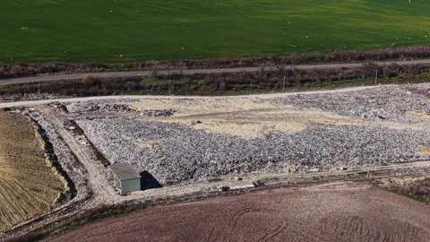 Waste management facility next to green fields Stock Footage 338188293