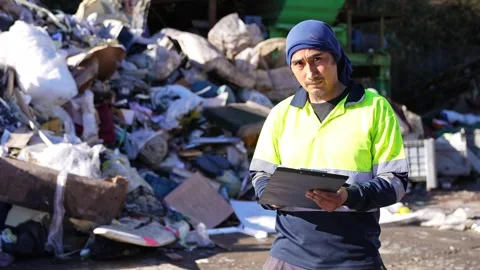 Waste management worker inspecting landfill site in slow motion Stock Footage 313917954