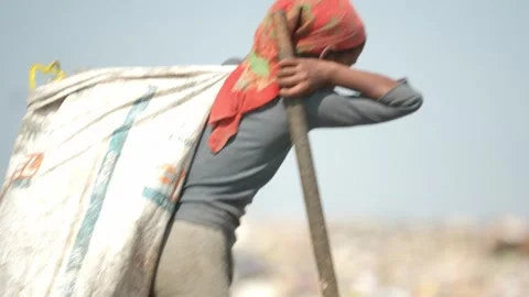 Waste Picker Carrying Heavy Sack Of Recyclables On Shoulder, Delhi Stock Footage 248056347