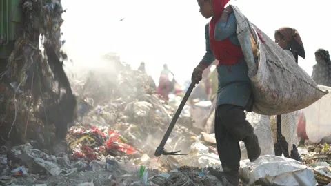 Waste Picker Carrying Sack Walking Across Garbage Dump In Delhi, India Stock Footage 248056665