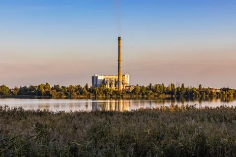 Waste processing plant at the lake sunset Stock Photos