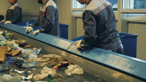 Waste processing plant. Waste on shipping tape. Waste sorting. People sort Stock-Footage 101286893