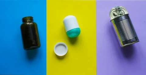 Waste for recycling located on the surface of different colors. Stock Photos