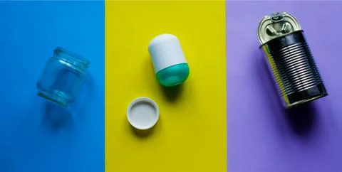 Waste for recycling located on the surface of different colors. Stock Photos