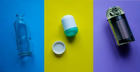 Waste for recycling located on the surface of different colors. Stock Photos