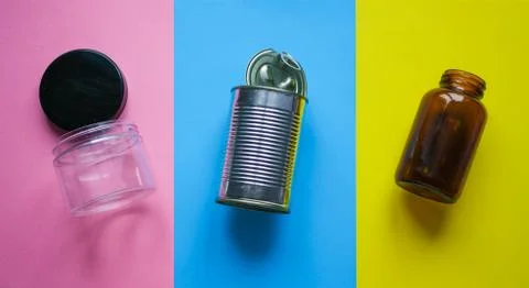 Waste for recycling located on the surface of different colors. Stock Photos