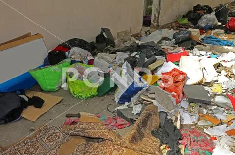 Waste in the rooms of an abandoned warehouse on the outskirts of a large city Stock Photos