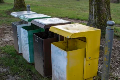 Waste separation with four differently coloured waste bins on a meadow Stock Photos