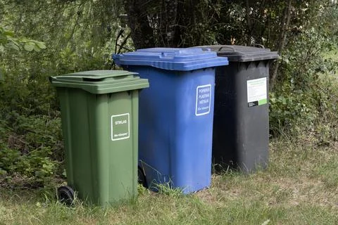 Waste sorting containers in nature Stock Photos
