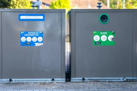 Waste sorting containers for paper and glass recycling on a street in Dijon Stock Photos