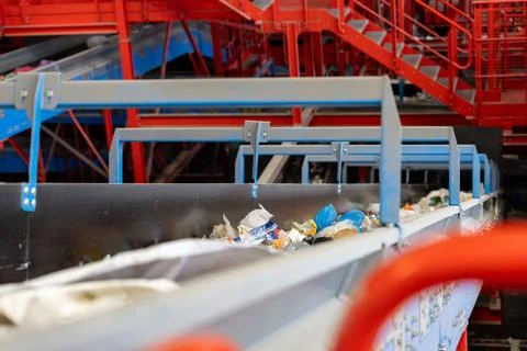 Waste sorting conveyor belt inside industrial recycling facility Photos