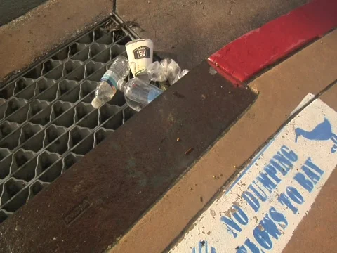 Waste on a storm drain Video stock 609893