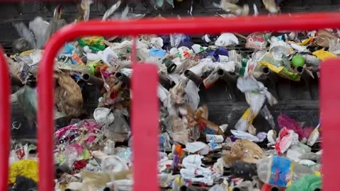 Waste stream dispersed across vibrating feeder section in recycling plant Stock Footage 333345215