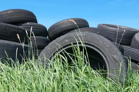 Waste Tyres Dumped in Grassland Stock Photos