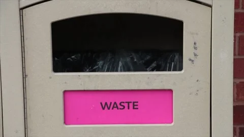 Waste word writing caption text light brown public garbage bin with bag in black Stock Footage 249754525