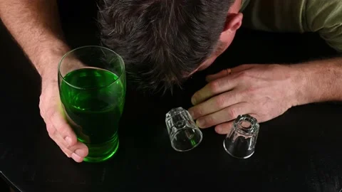 Wasted drunk man passed on on a table during St Patricks day celebrations Stock Footage 230957031