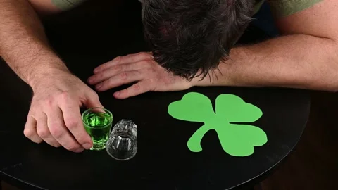 Wasted drunk man passed on on a table during St Patricks day celebrations Stock Footage 231558399