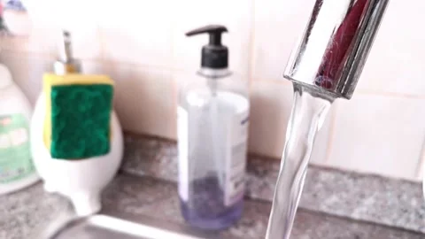 Wasted water from the tap selective focus Stock Footage 213967447