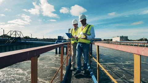 Wastewater operators examining water samples at a wastewater cleaning facility Stock Footage 145304797