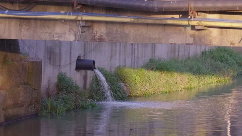 Wastewater pouring from pipe under bridge 스톡 동영상 283756021