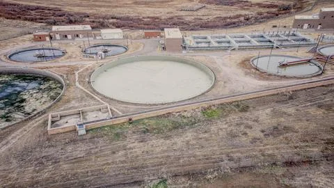 Wastewater Processing Tanks and Utility Buildings in Public Works Stock Photos