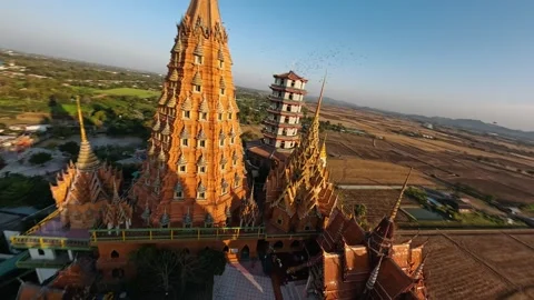 Wat tham sua, a buddhist temple on a hill near rice fields in Kanchanaburi Stock Footage 316785745